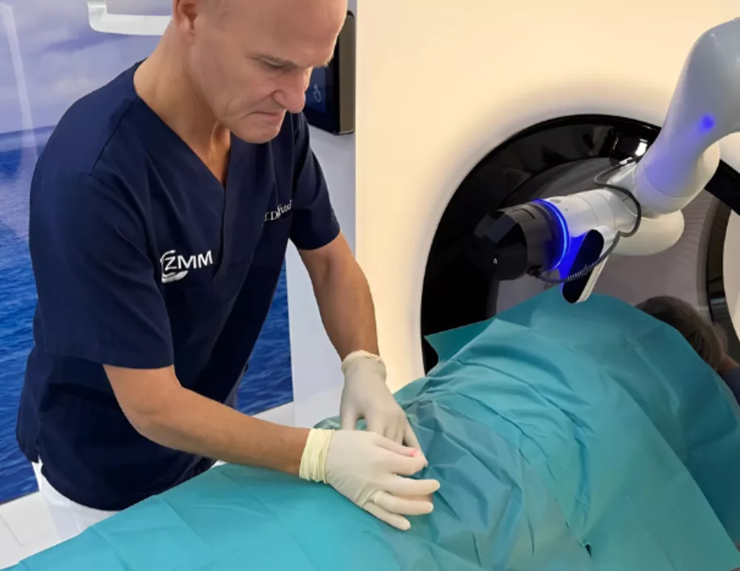 surgeon using robot arm